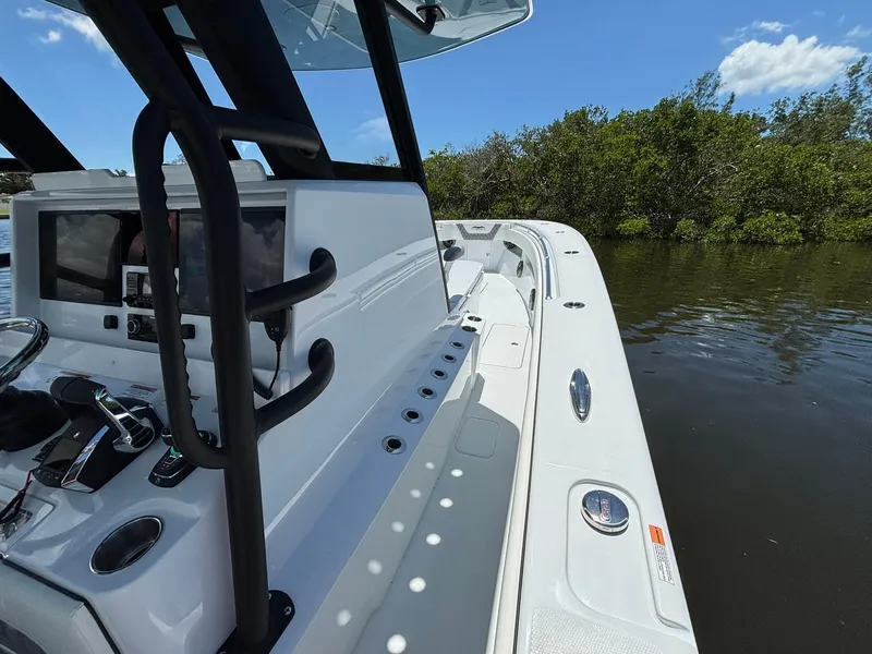 Slide: The Image of 2026 Invincible 36 Open Fisherman boat on calm water, featuring sleek design and advanced controls. - 17