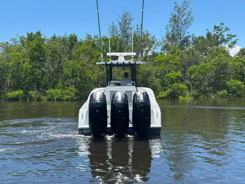 Slide: The Image of 2026 Invincible 36 Open Fisherman boat with quad engines on a calm waterway. - 2
