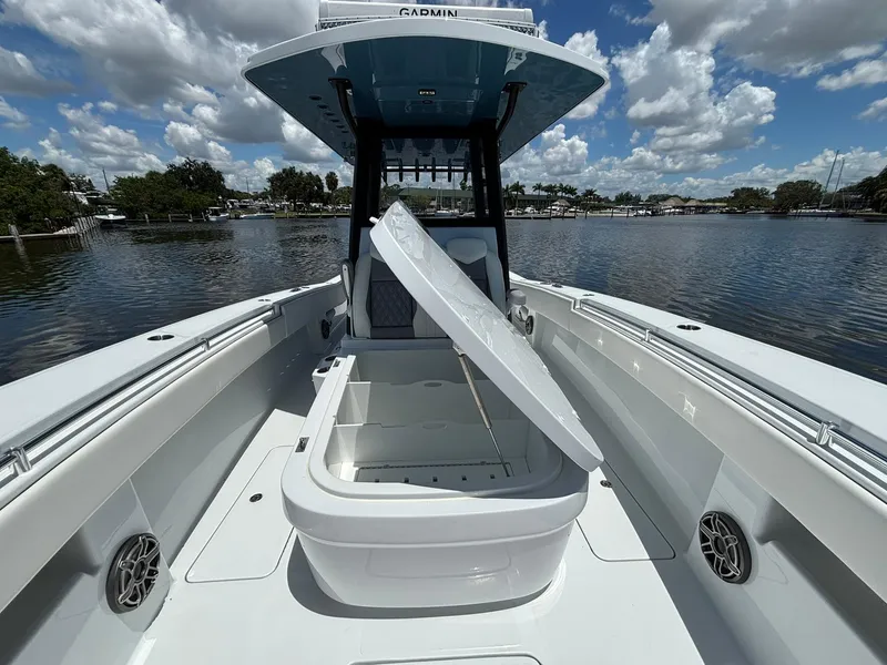 Slide: The Image of 2026 Invincible 36 Open Fisherman boat with open storage compartment on a sunny day. - 23