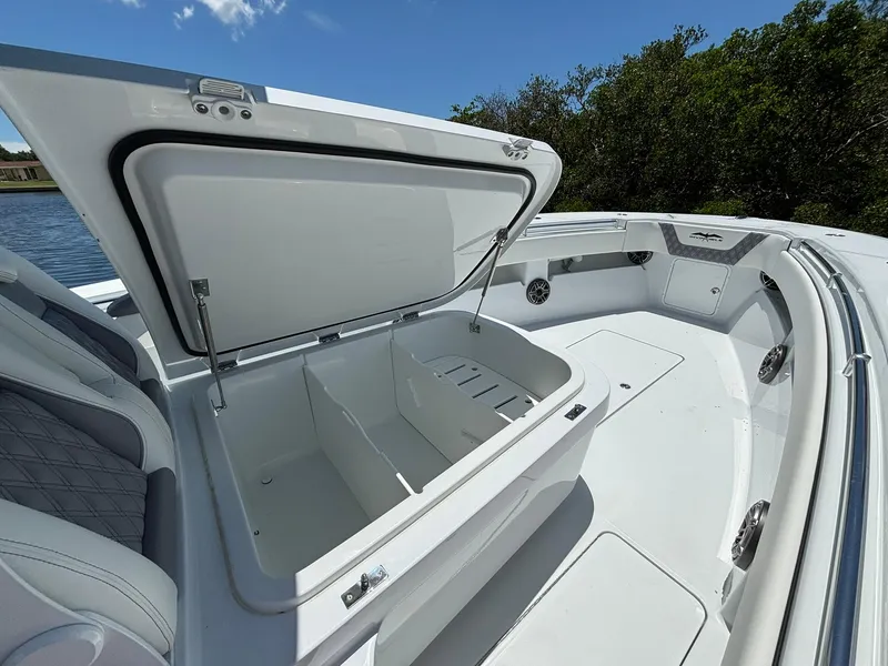 Slide: The Image of 2026 Invincible 36 Open Fisherman boat with open storage compartment, sleek design, and spacious deck. - 24