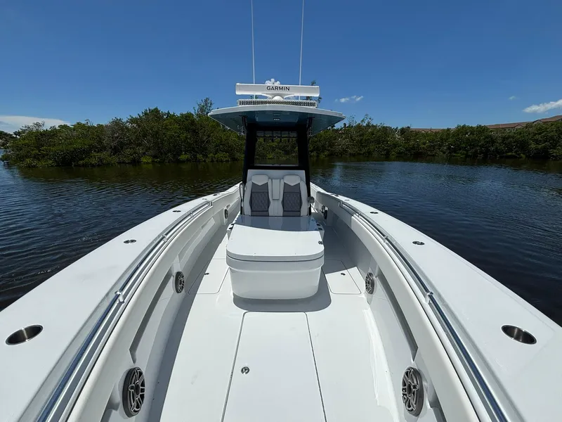 Slide: The Image of 2026 Invincible 36 Open Fisherman boat on calm water, featuring sleek design and spacious deck. - 25