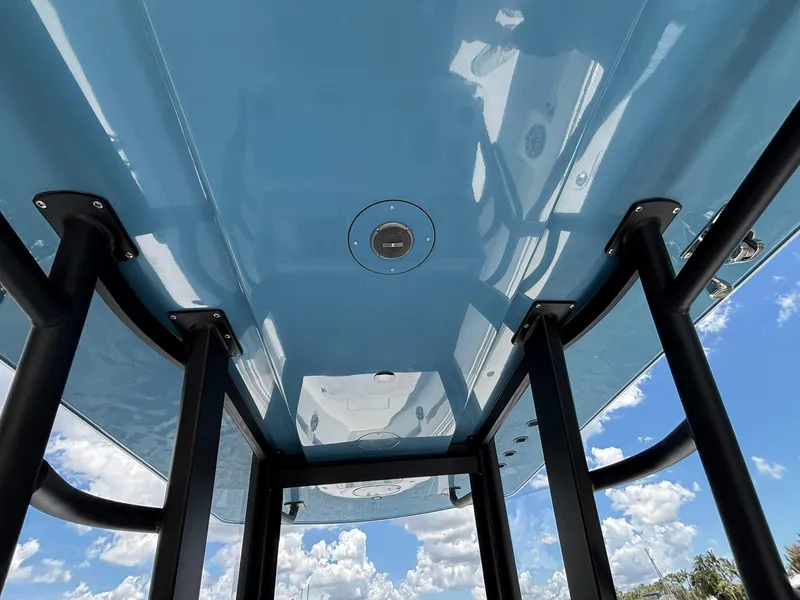 Slide: The Image of 2026 Invincible 36 Open Fisherman boat, underside view with blue sky background. - 27