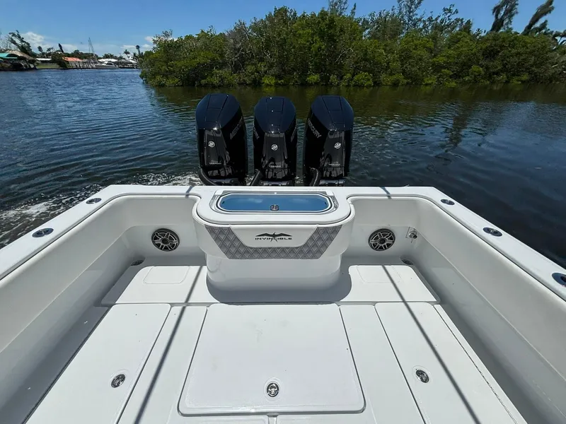 Slide: The Image of 2026 Invincible 36 Open Fisherman boat with triple engines on a calm waterway. - 8