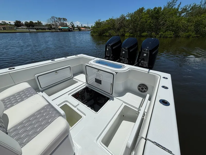 Slide: The Image of 2026 Invincible 36 Open Fisherman boat with triple Mercury engines on calm water. - 9