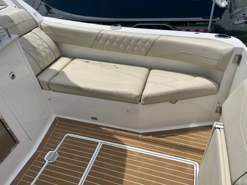 Slide: The Image of Luxurious seating area on 2019 Regal 33 SAV boat with beige cushions and wood flooring. - 17