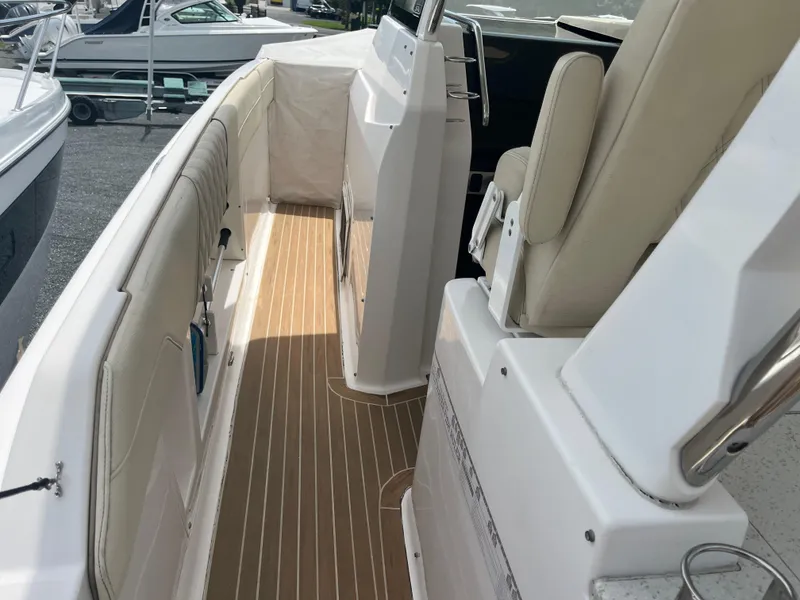 Slide: The Image of 2019 Regal 33 SAV boat interior with beige seating and wood-style flooring. - 22