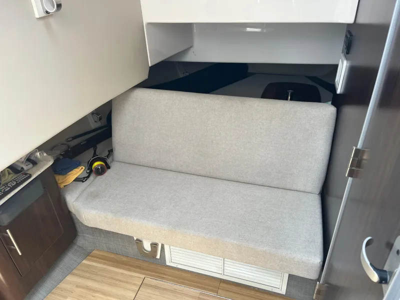 Slide: The Image of 2019 Regal 33 SAV interior with beige seating and wooden flooring. - 26