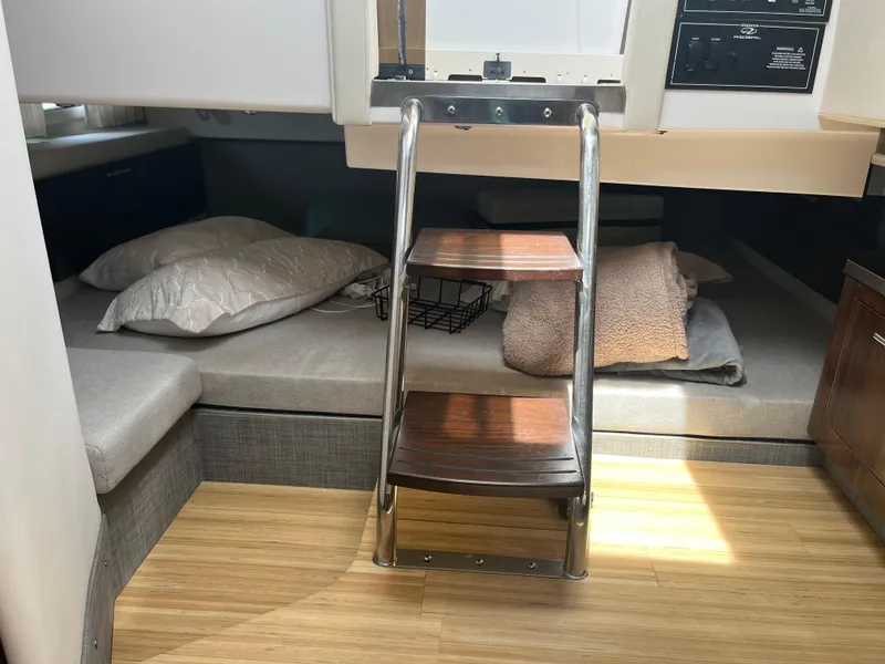 Slide: The Image of Interior cabin of 2019 Regal 33 SAV boat with wooden steps and bedding. - 27