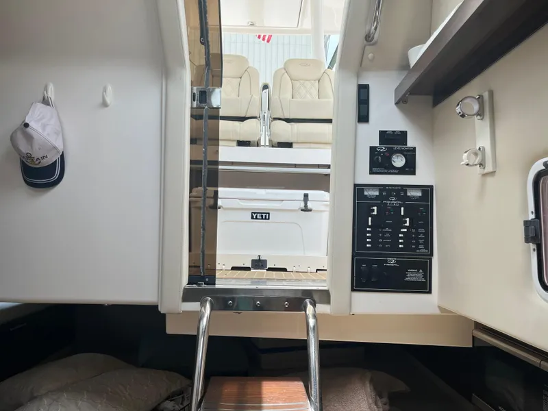 Slide: The Image of Interior view of 2019 Regal 33 SAV boat cabin with control panel and seating area. - 29