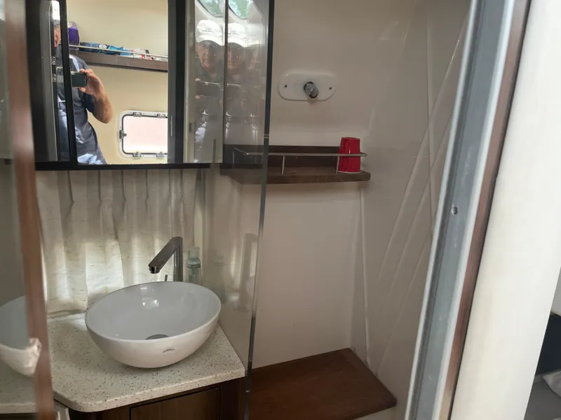 Slide: The Image of Bathroom interior of 2019 Regal 33 SAV boat with sink and mirror. - 31