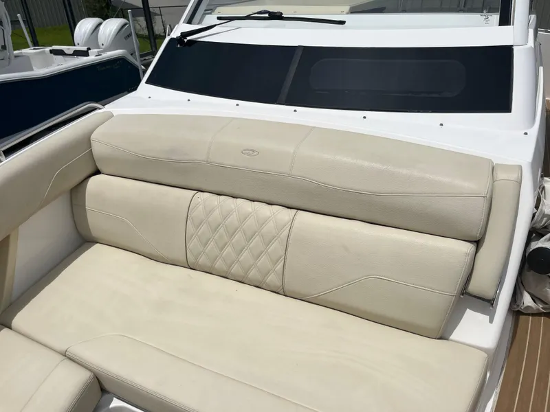 Slide: The Image of Luxurious seating on a 2019 Regal 33 SAV boat, featuring elegant beige upholstery. - 34