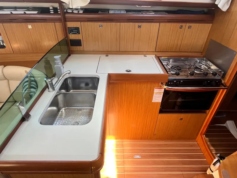 Slide: The Image of Galley kitchen in 2008 Jeanneau Sun Odyssey 36i sailboat with sink and stove. - 11