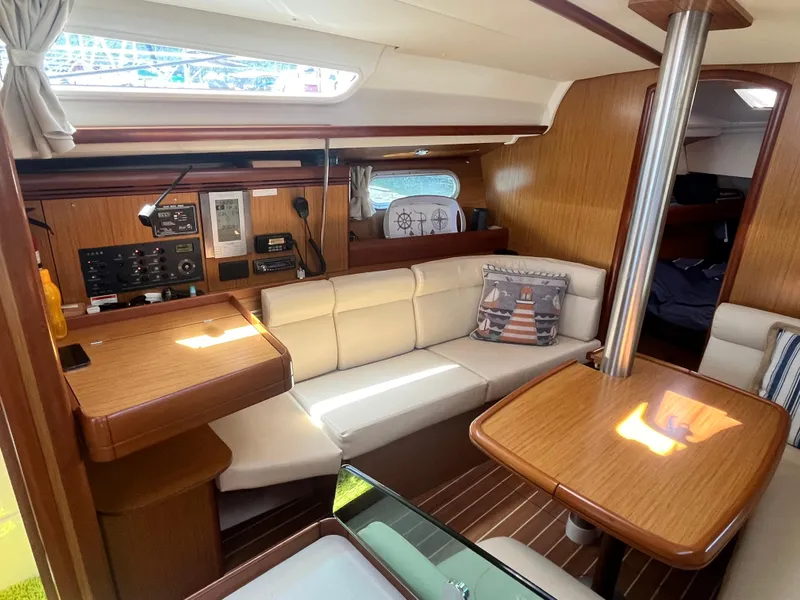 Slide: The Image of Interior of 2008 Jeanneau Sun Odyssey 36i sailboat with cozy seating and wooden finishes. - 12