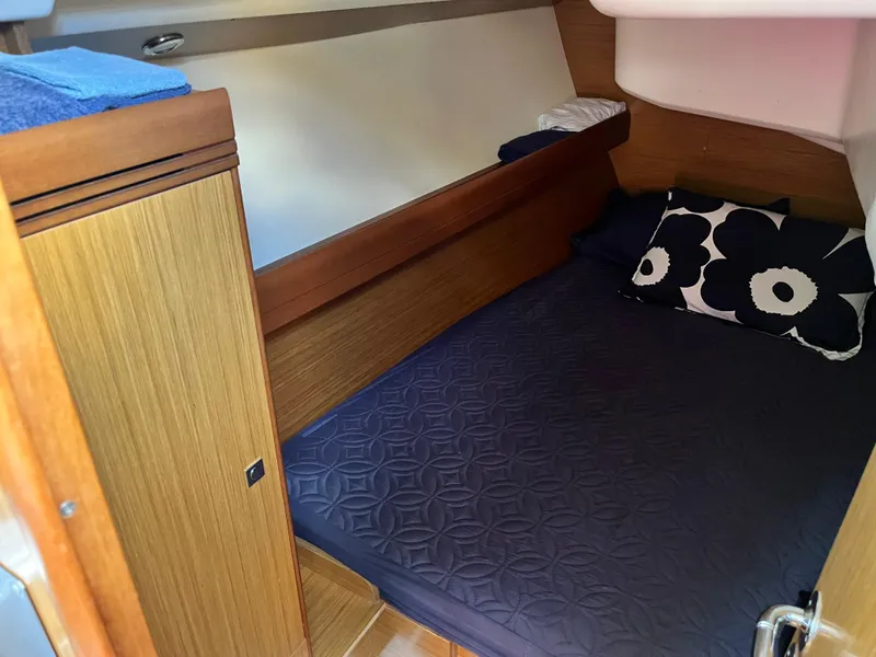 Slide: The Image of Cozy cabin interior of 2008 Jeanneau Sun Odyssey 36i with dark bedding and floral pillow. - 16