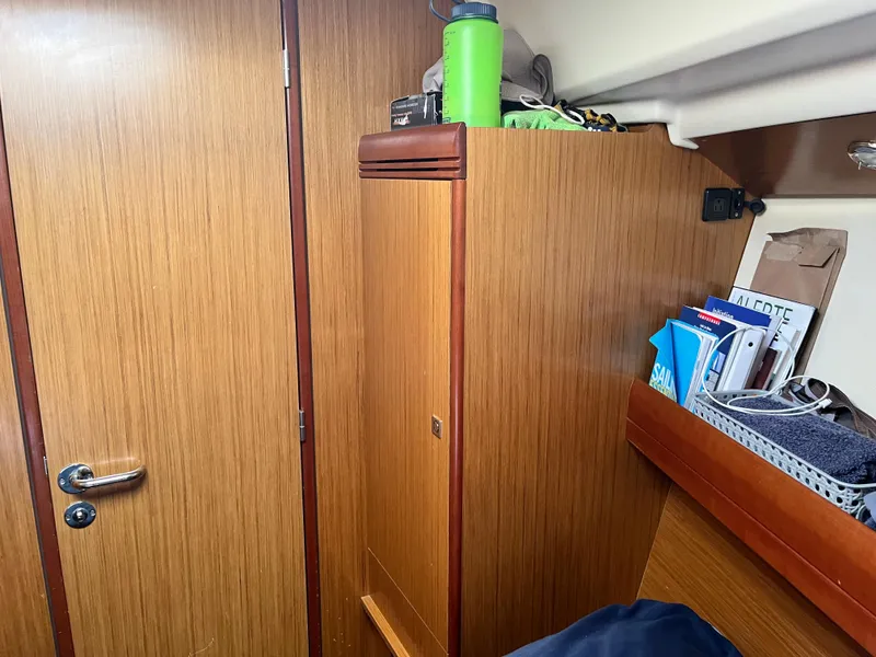 Slide: The Image of Interior of 2008 Jeanneau Sun Odyssey 36i sailboat with wooden cabinetry and storage. - 17