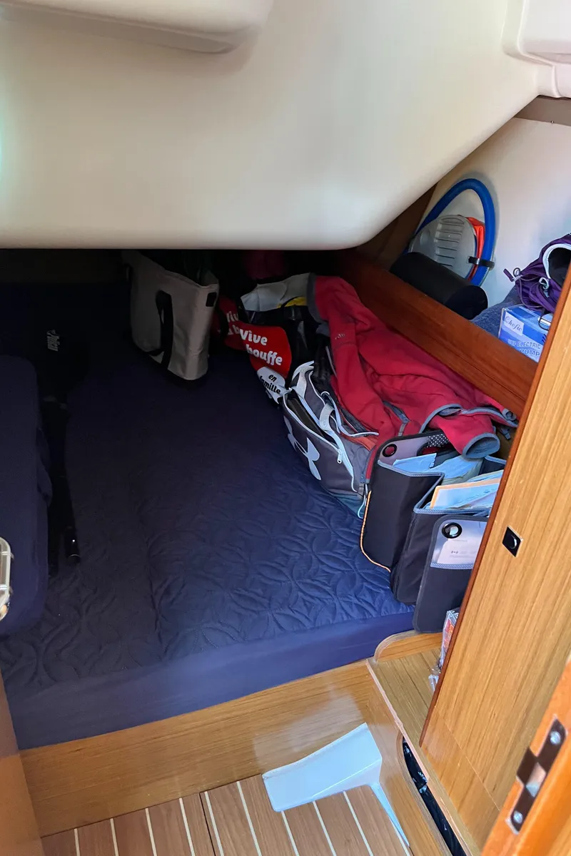 Slide: The Image of Cozy cabin interior of 2008 Jeanneau Sun Odyssey 36i with storage and bags. - 18
