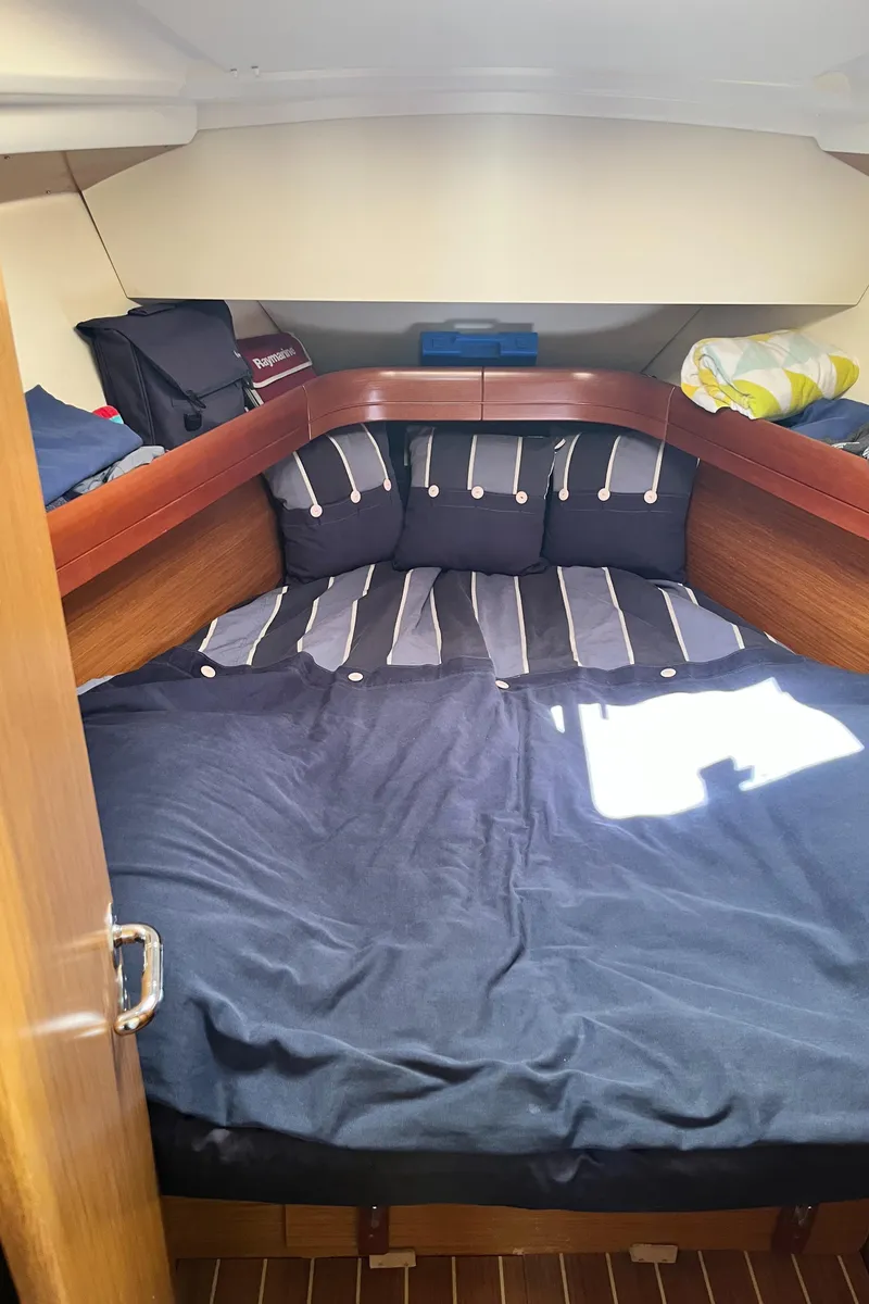 Slide: The Image of Cozy cabin interior of 2008 Jeanneau Sun Odyssey 36i sailboat with striped bedding. - 20