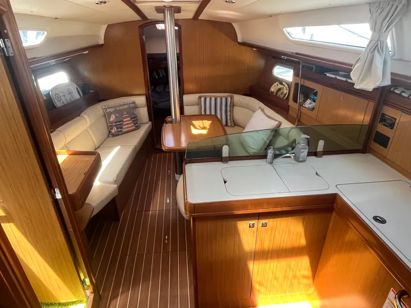 Slide: The Image of Interior of 2008 Jeanneau Sun Odyssey 36i yacht with elegant wood finish and cozy seating. - 8