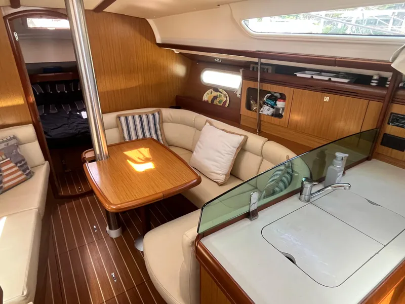 Slide: The Image of Interior of 2008 Jeanneau Sun Odyssey 36i sailboat with cozy seating and wooden finishes. - 9