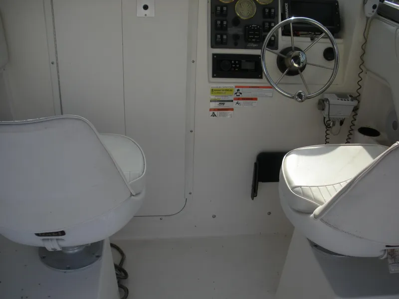 Slide: The Image of 2008 Seaswirl Striper 2101 Alaskan boat interior with steering wheel and seats. - 10