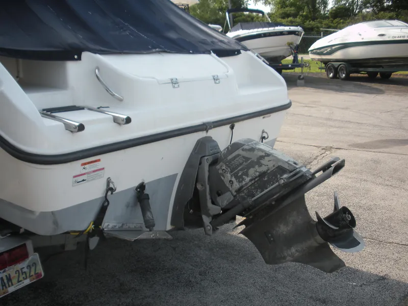 Slide: The Image of 2008 Seaswirl Striper 2101 Alaskan boat with visible outboard motor in a parking area. - 13