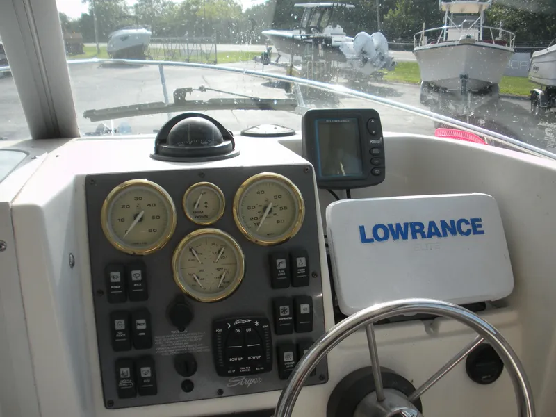 Slide: The Image of 2008 Seaswirl Striper 2101 Alaskan boat dashboard with gauges and Lowrance navigation system. - 6