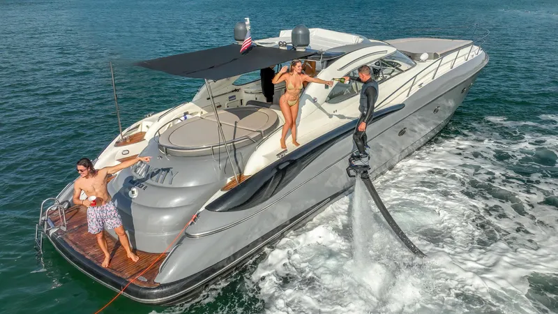 The Image of Sunseeker Predator 58 yacht, 1999 model, with people enjoying water activities. - 0