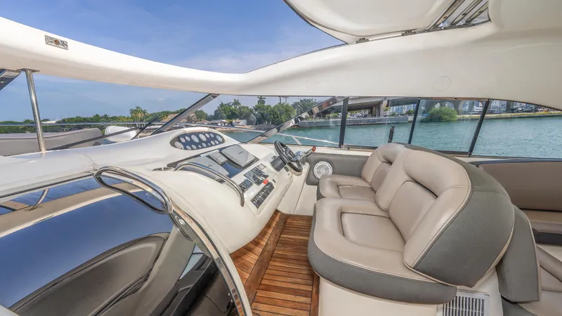 Slide: The Image of Interior of 1999 Sunseeker Predator 58 yacht with luxurious seating and modern dashboard. - 12