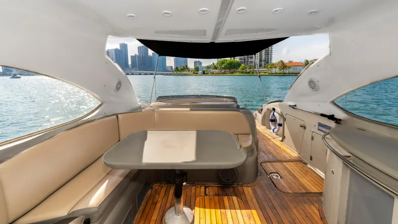 Slide: The Image of Interior view of 1999 Sunseeker Predator 58 yacht with elegant seating and waterfront backdrop. - 22