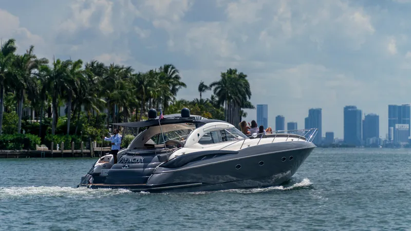 Slide: The Image of Sunseeker Predator 58 yacht cruising near city skyline, 1999 model. - 28