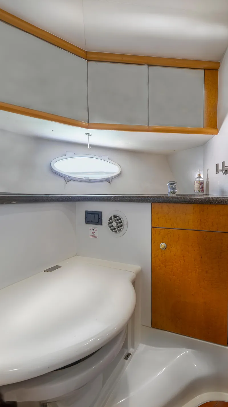 Slide: The Image of 1999 Sunseeker Predator 58 yacht bathroom with modern fixtures and wood accents. - 33