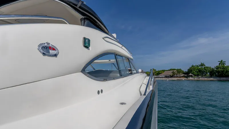 Slide: The Image of Sunseeker Predator 58 yacht, 1999 model, cruising on clear blue waters. - 34
