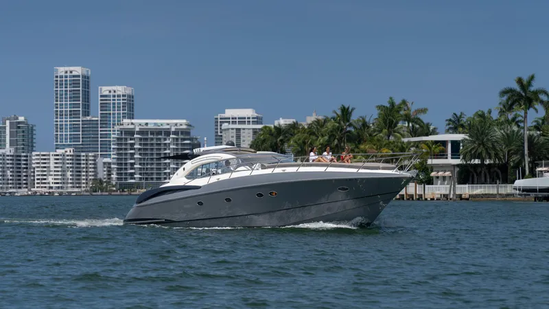 Slide: The Image of Sunseeker Predator 58 yacht cruising near city skyline, 1999 model. - 35