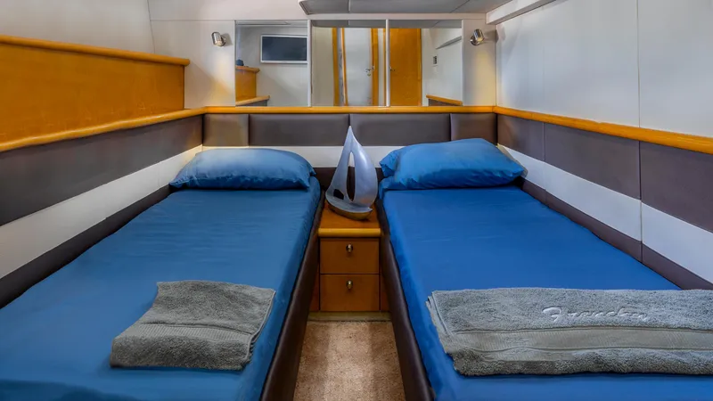 Slide: The Image of Twin cabin interior of 1999 Sunseeker Predator 58 yacht with blue bedding. - 36