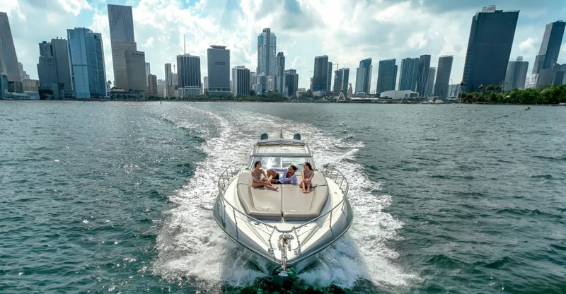 Slide: The Image of Sunseeker Predator 58 yacht cruising near city skyline, 1999 model. - 7