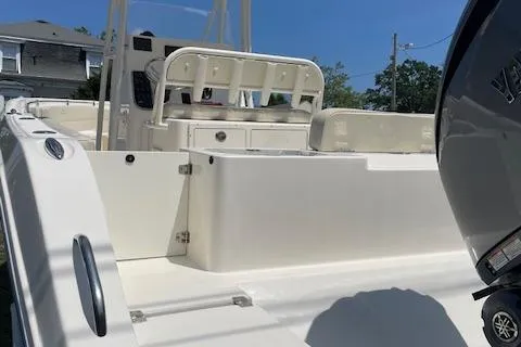 Slide: The Image of 2023 Cobia 237CC boat interior with seating and Yamaha outboard motor. - 2
