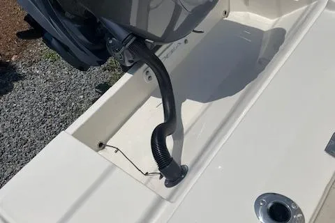 Slide: The Image of 2023 Cobia 237CC boat engine compartment with hose and fittings. - 3