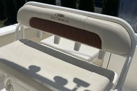 Slide: The Image of 2023 Cobia 237CC boat seat with white and brown upholstery. - 5