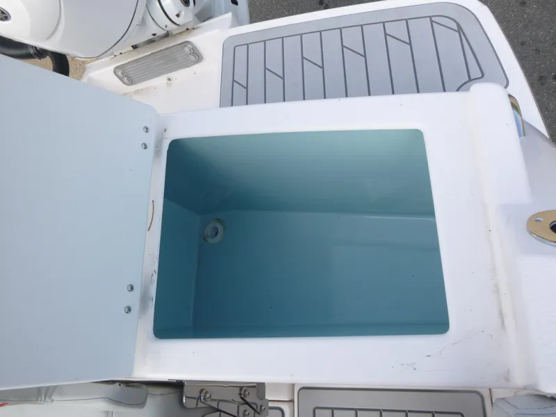 Slide: The Image of Open storage compartment on 2025 Solara S-250 CW boat, featuring a clean, spacious interior. - 18