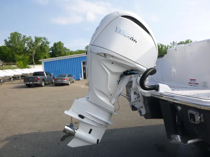 Slide: The Image of Outboard motor on a Solara S-250 CW boat, 2025 model, in a marina setting. - 21