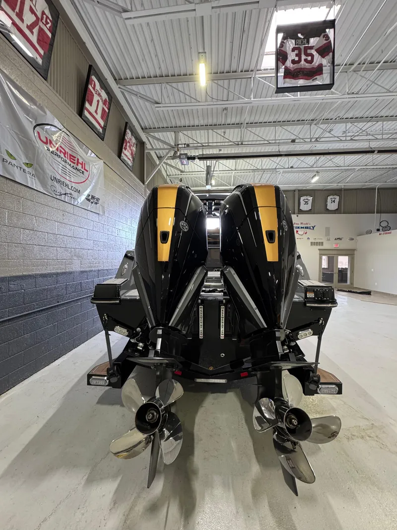 Slide: The Image of 2025 Sunsation 32 CCX boat with dual outboard engines in a showroom. - 10