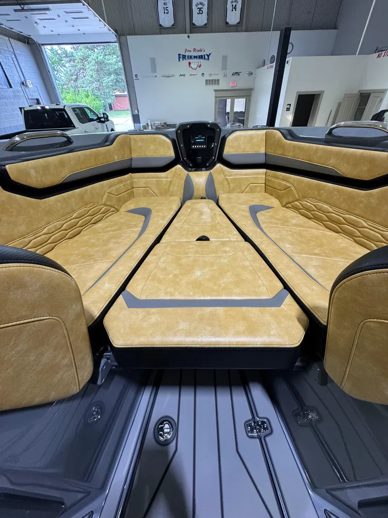 Slide: The Image of 2025 Sunsation 32 CCX boat interior with tan leather seating and modern design. - 11