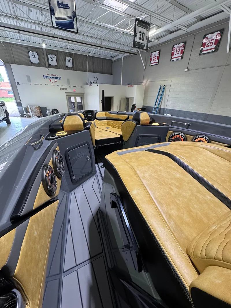 Slide: The Image of 2025 Sunsation 32 CCX boat interior with tan leather seats and modern design. - 12