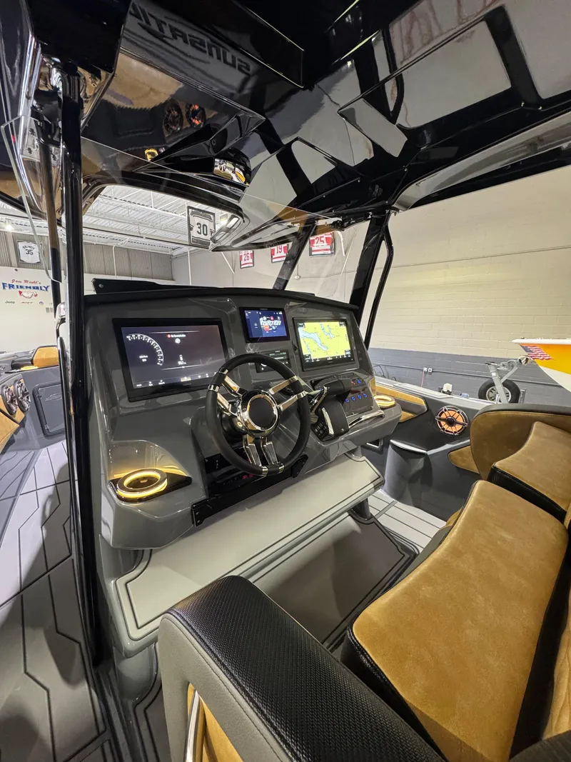 Slide: The Image of 2025 Sunsation 32 CCX boat cockpit with modern dashboard and navigation screens. - 16