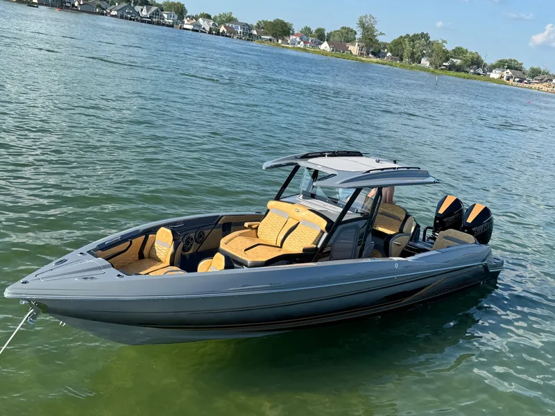 Slide: The Image of 2025 Sunsation 32 CCX boat on water, featuring sleek design and dual engines. - 20