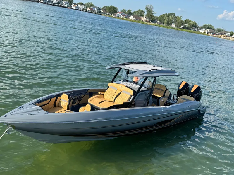 Slide: The Image of 2025 Sunsation 32 CCX boat on calm water, featuring sleek design and luxurious seating. - 21