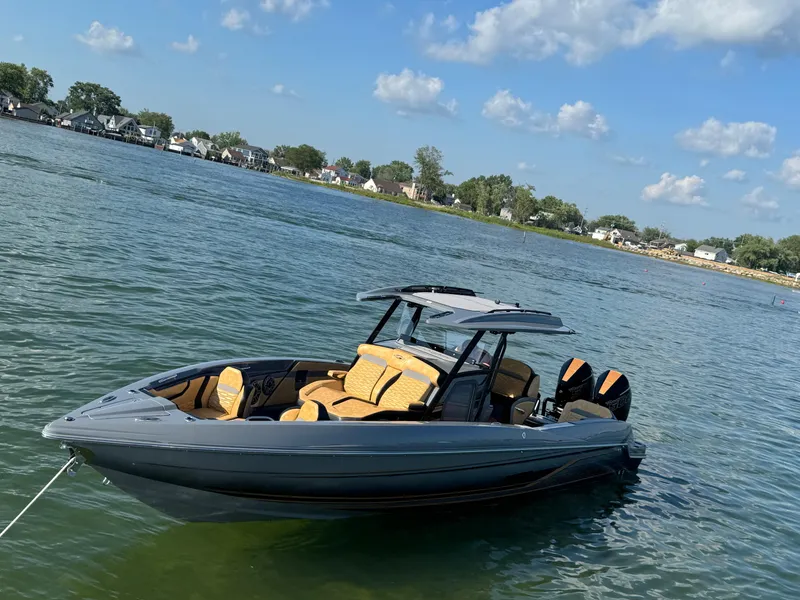 Slide: The Image of 2025 Sunsation 32 CCX boat on a lake under a blue sky. - 23