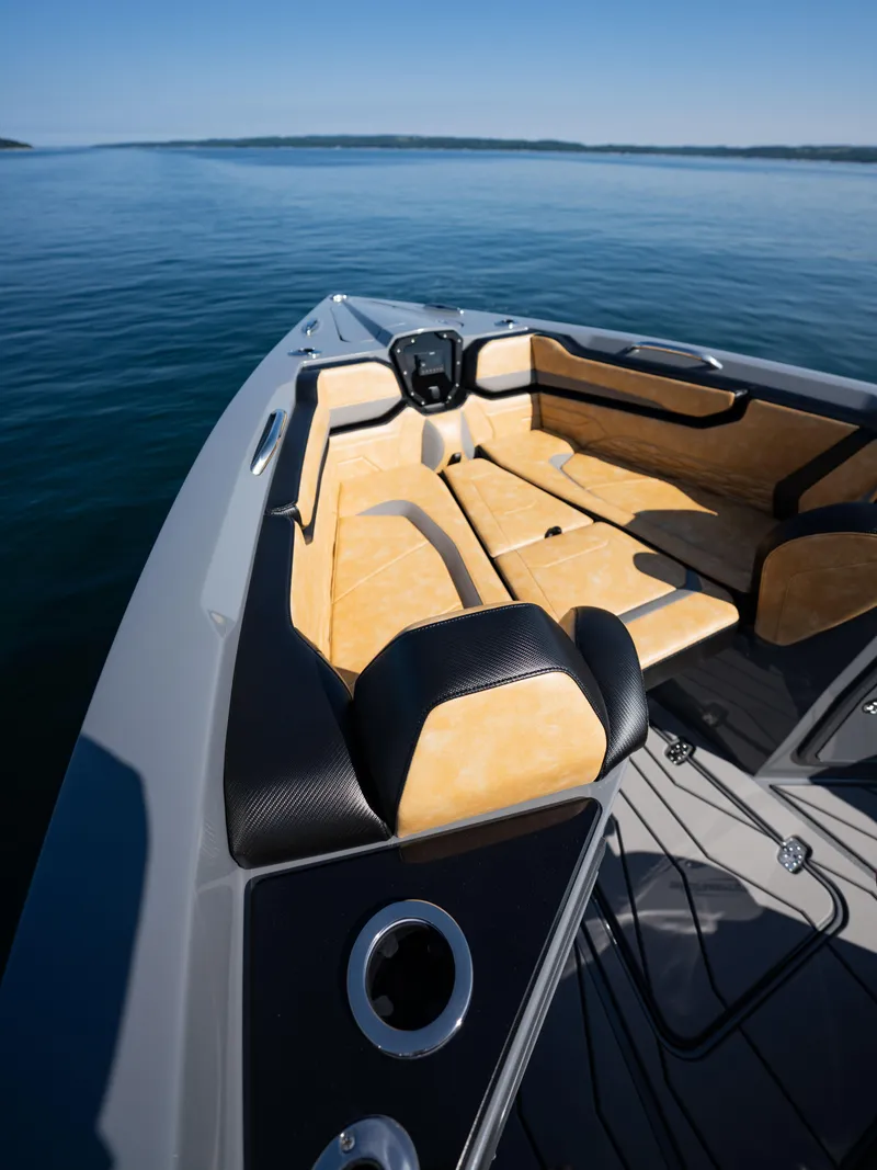 Slide: The Image of 2025 Sunsation 32 CCX boat interior with tan seating on calm water. - 6