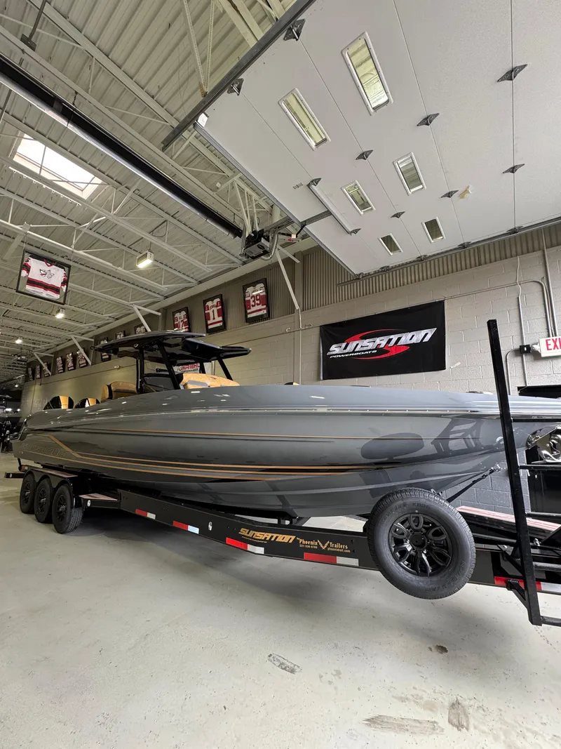 Slide: The Image of 2025 Sunsation 32 CCX boat on trailer in showroom, featuring sleek design and modern aesthetics. - 8