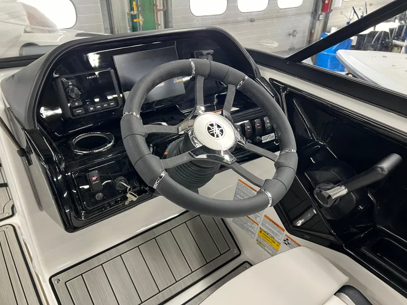 Slide: The Image of 2024 Yamaha Boats 195S cockpit with steering wheel and captain's chair. - 6